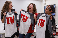 Three students holding IU Fort Wayne shirts.